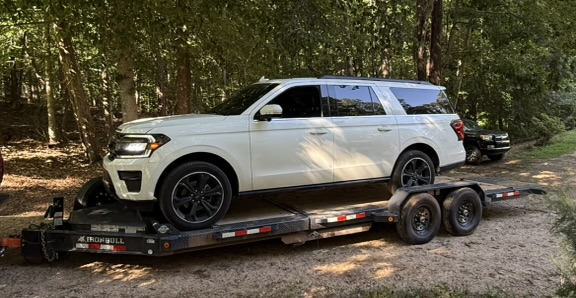IronBull tilt trailer with Ford Expedition - Heavy-duty vehicle hauling trailer for rent
